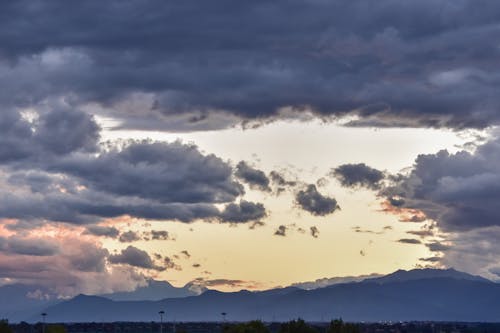 Silhouettes of Mountains Under Dramatic Sky