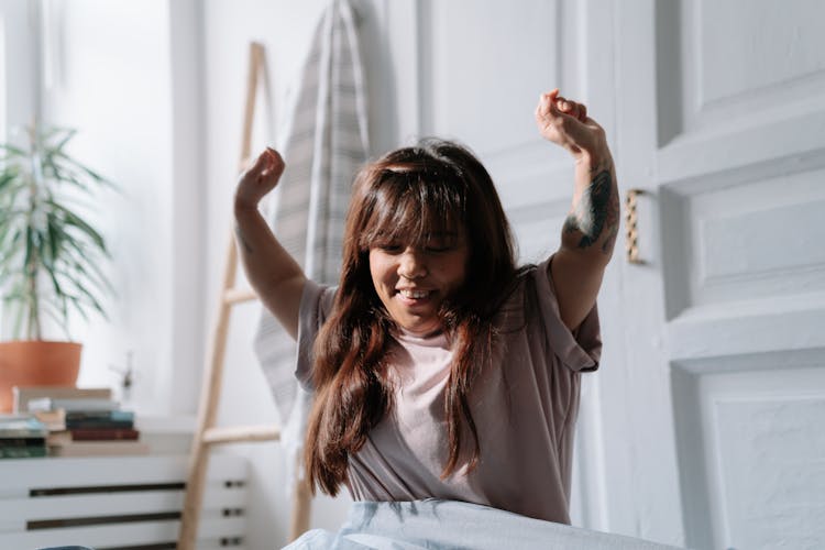 Woman With Dwarfism Stretching While Waking Up