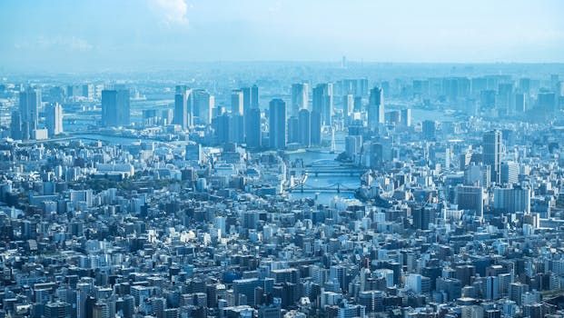 A breathtaking aerial view of Tokyo's urban landscape with prominent skyscrapers under clear skies.