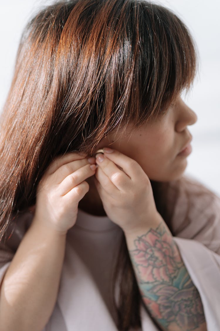 Girl With Dwarfism Putting On Earring