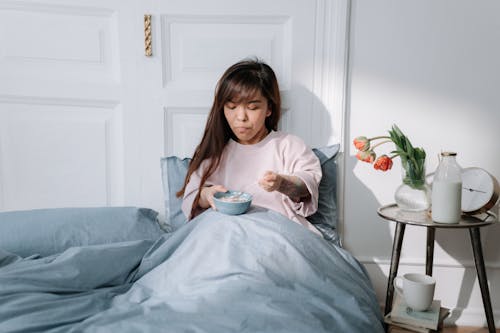 Woman eating breakfast in a bed