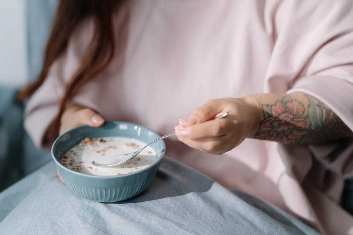 Free Woman eating cereal with milk Stock Photo