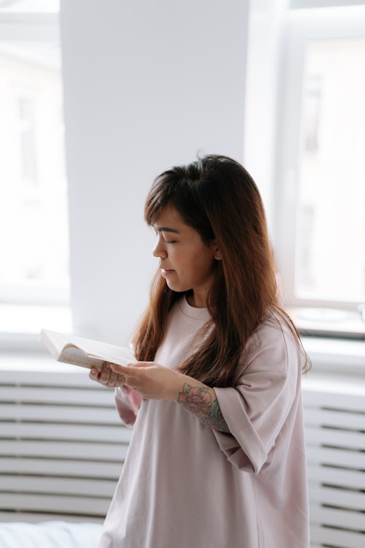 Dwarf Woman Standing And Reading Book