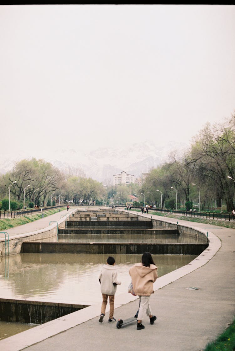 Brother And Sister Roaming Around The Park