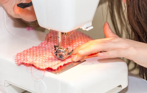 Free A Person Using a Sewing Machine Stock Photo