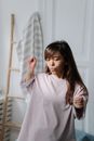 Young dwarf woman listening to music and dancing in her bedroom