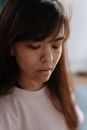 Young dwarf woman looking down expressing loneliness