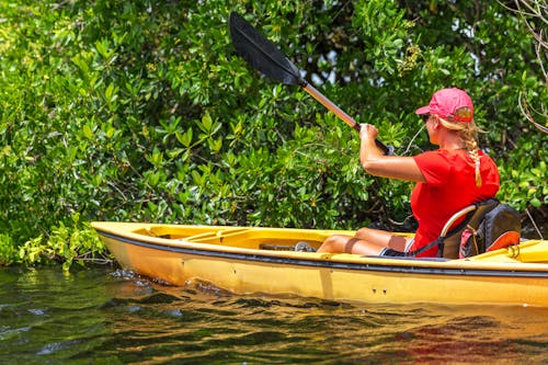 Woman paddling a Canoe Boat 