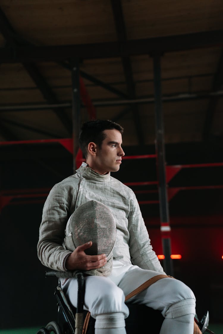 Man In Wheelchair Holding Fencing Mask