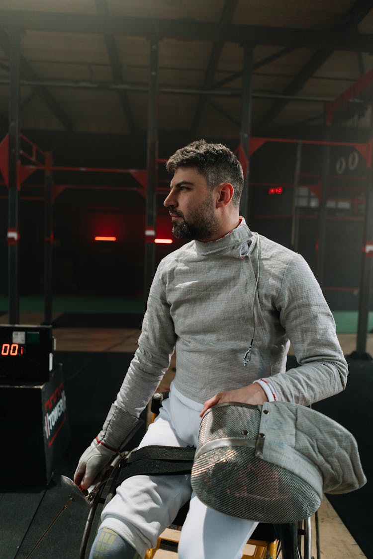 Man In Wheelchair Holding Fencing Mask