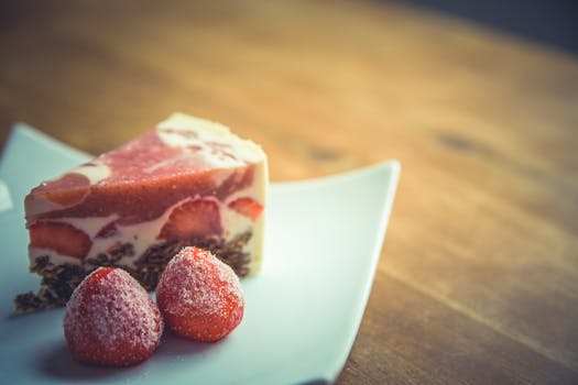 Pink and White Stawberry Cake on Top of White Ceramic Square Plate