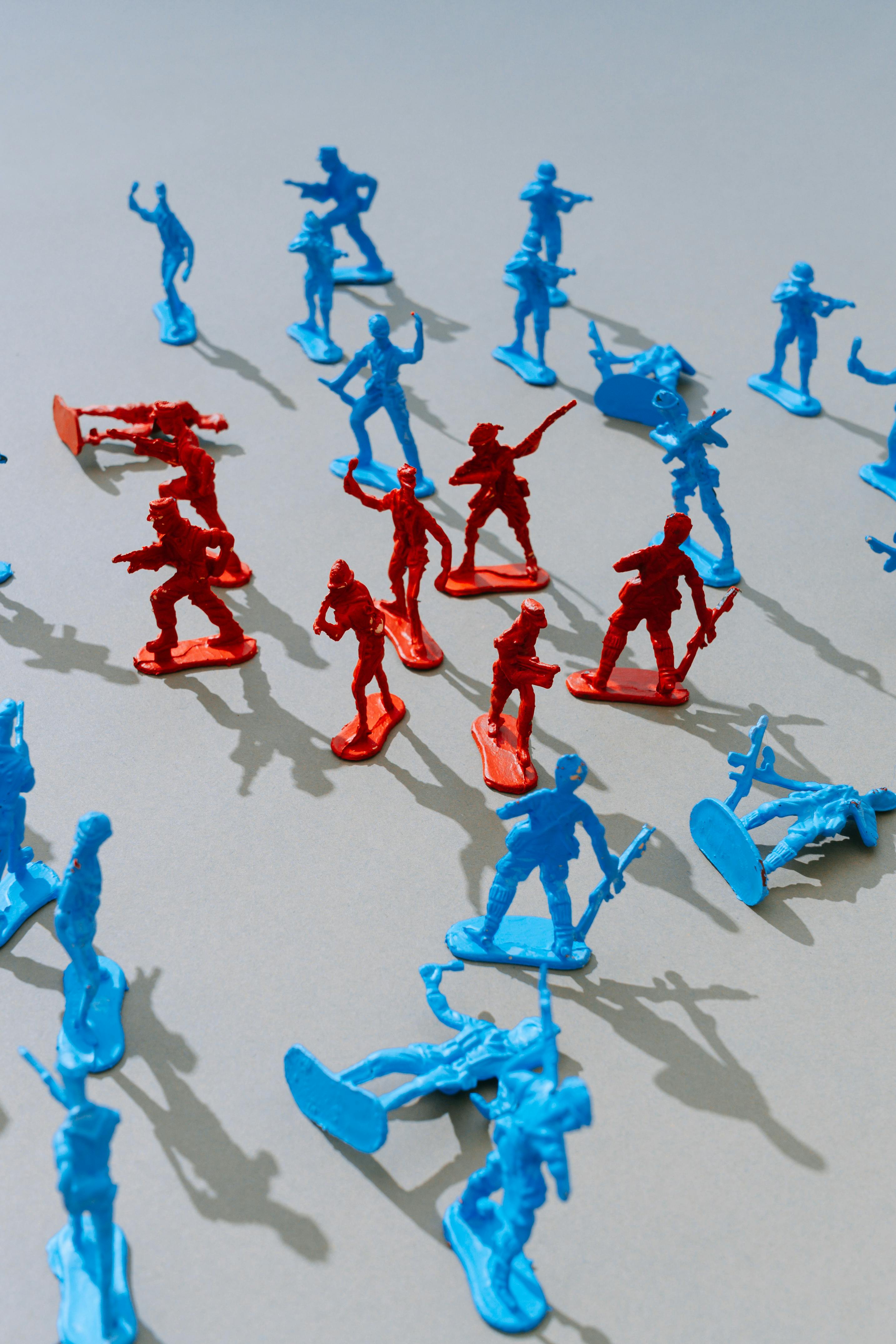 group of red toy soldiers surrounded by blue ones