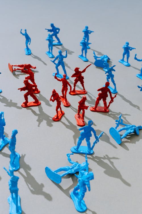 Group of Red Toy Soldiers Surrounded by Blue Ones