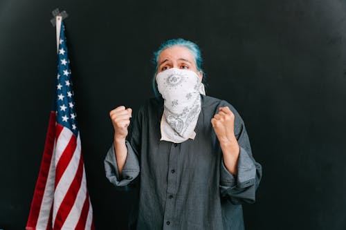 A Woman Covering her face with a Scarf