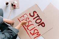 Person Holding Brown and Red Love Print Cardboard Box