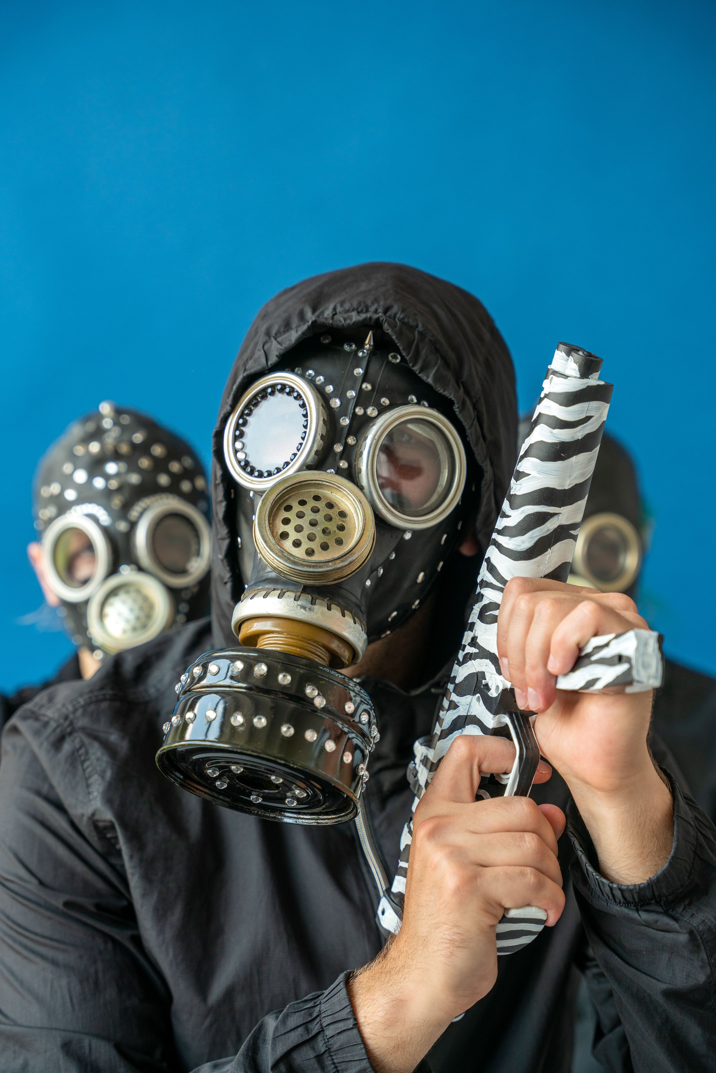 A Person Wearing Mask Holding a Gun · Free Stock Photo