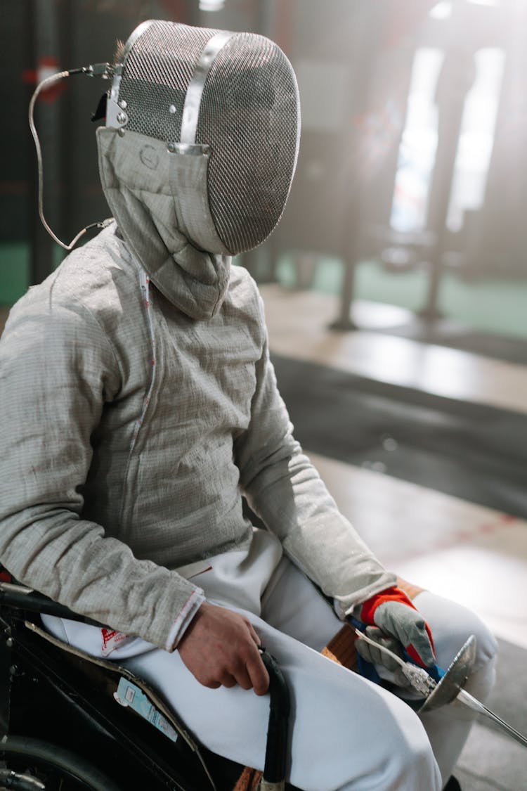 Paralympic Sitting On Wheelchair Wearing Fancing Mask 