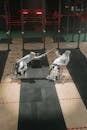 People in White Clothes Competing while Wearing Fencing Mask