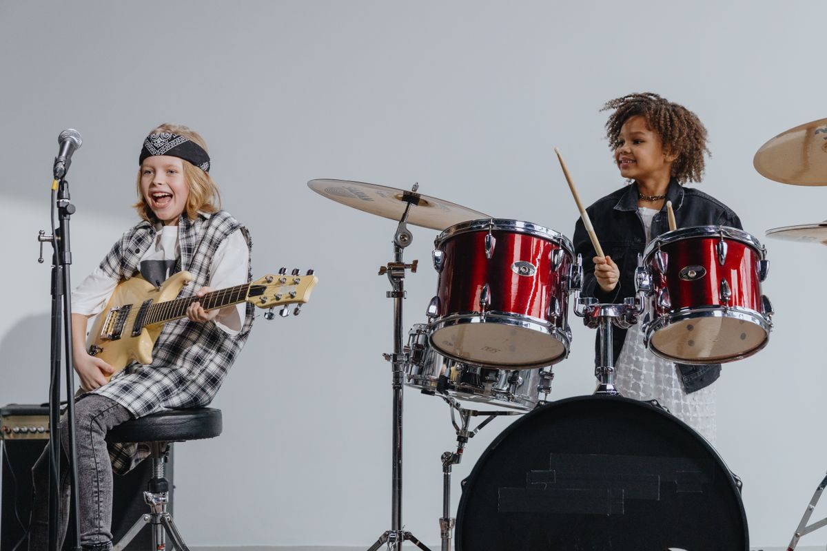 Kids having fun with guitars in a music studio