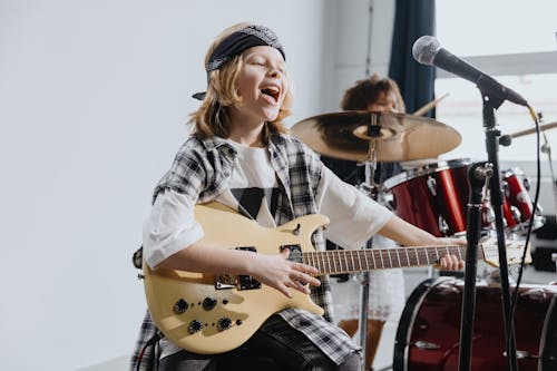 Photo of a Kid Playing an Electric Guitar