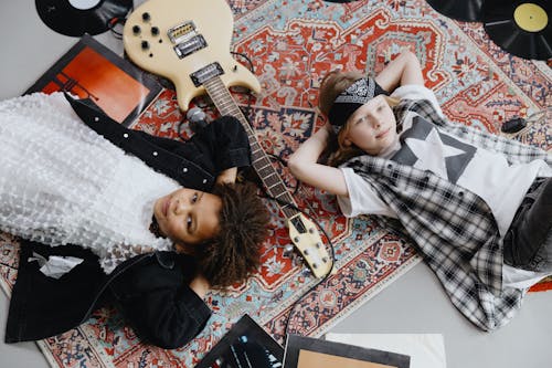 Two Kids lying on a Carpet 