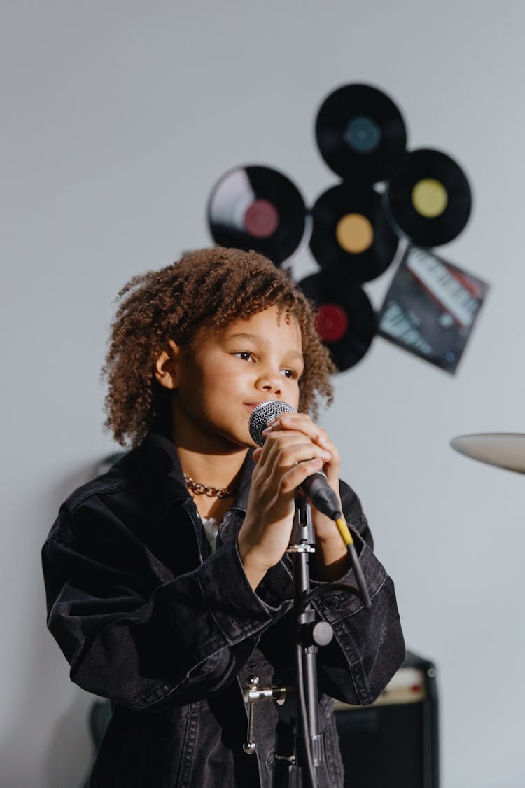 An Afro-Haired Kid Singing 