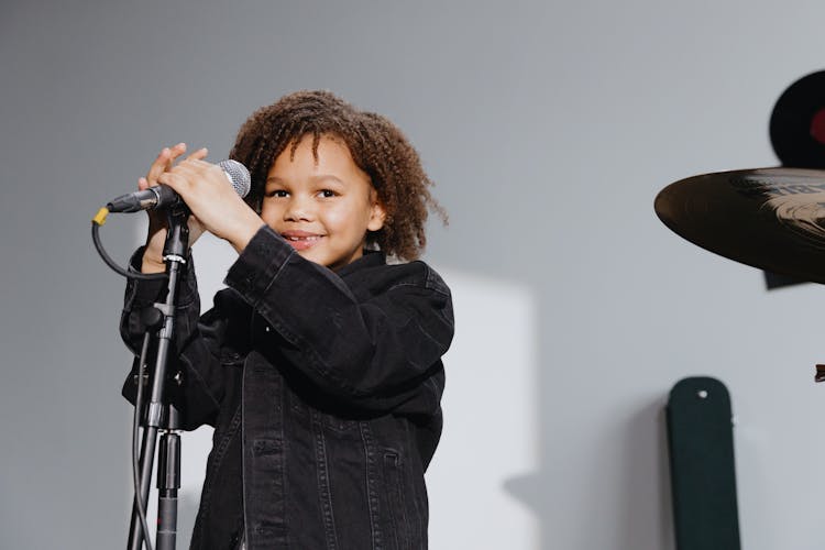 An Afro-Haired Kid Singing 