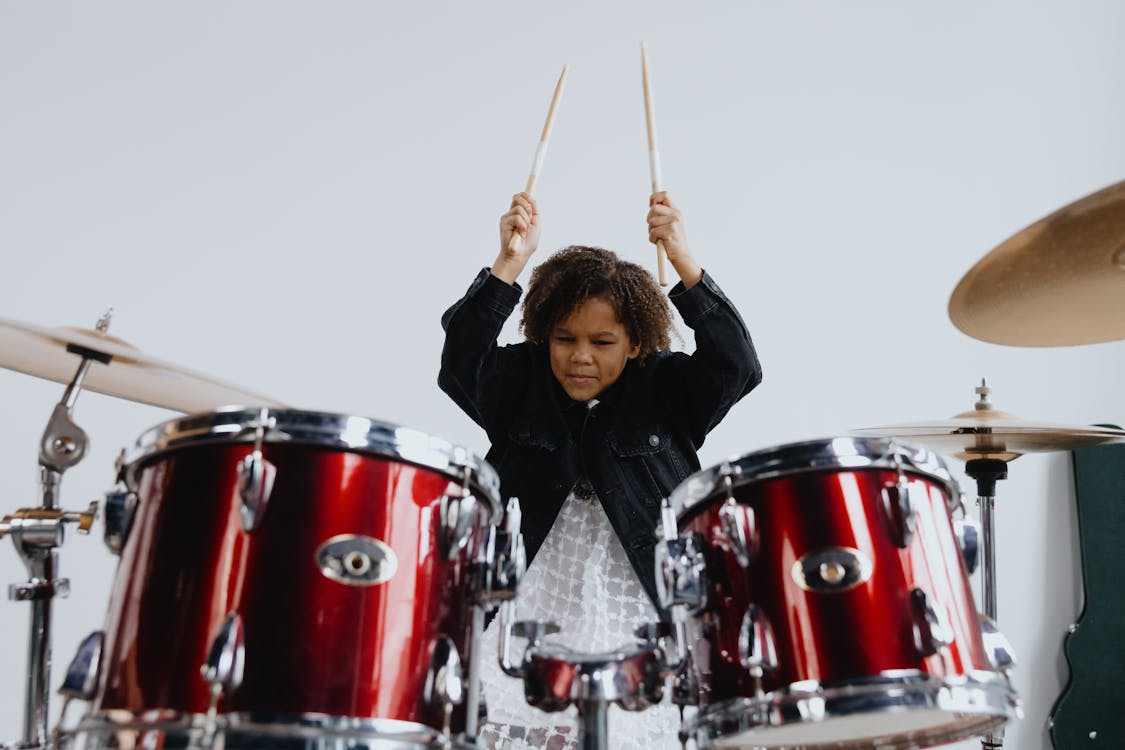 Free Close-Up Shot of a Girl Playing Drums Stock Photo