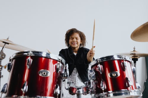 Girl Having Fun Playing Bass Drum