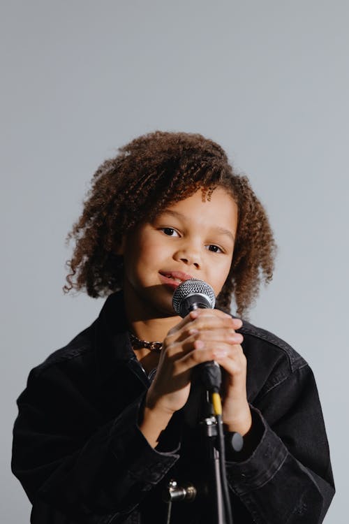 Free An Afro-Haired Kid Singing Stock Photo