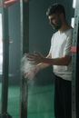 Athlete using talc on gym