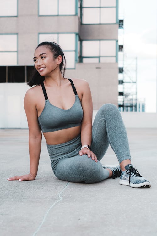 Pretty Woman in Activewear Sitting on the Ground