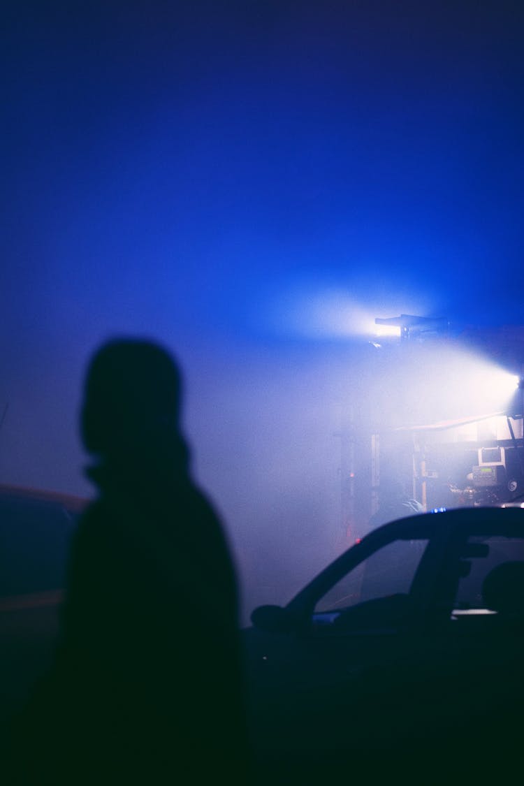 Silhouette Of Person Near Car In Darkness