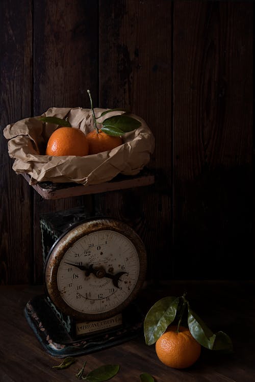 Three Orange Fruits and Analog Scale