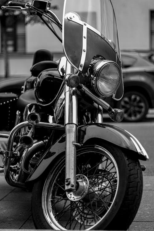 A Grayscale Photo of a Motorcycle Parked on the Street