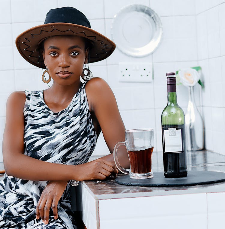 Woman Posing With Glass And Bottle Of Alcohol