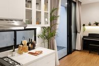 White Wooden Cabinet With Green Potted Plant