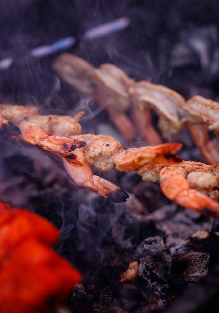 Tandoori prawn skewers over a smoky grill