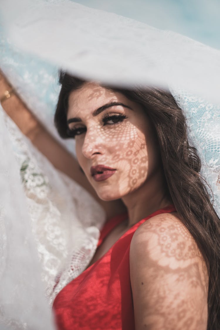 Woman In Red Sleeveless Top Holding A Lace Fabric