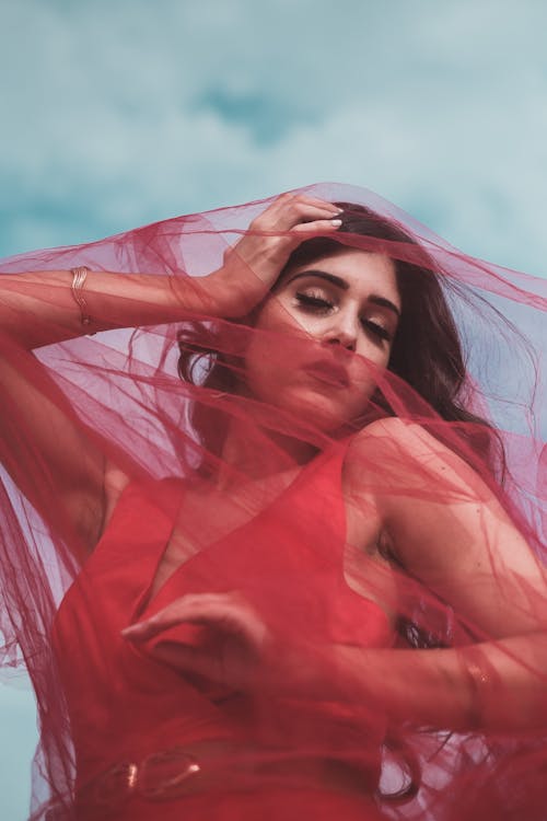 Low-Angle Shot of a Woman Covered with Red Tulle