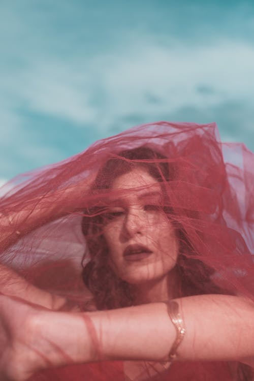 A Woman Covered with Red Tulle