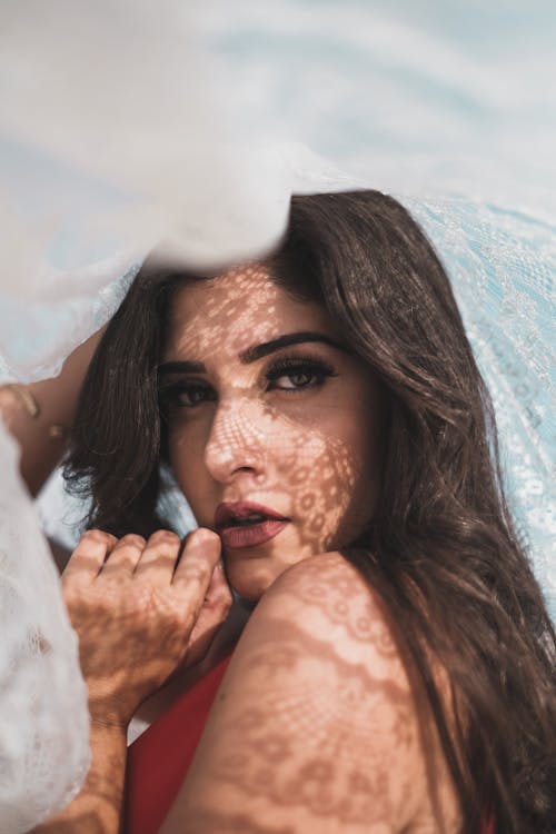 Portrait of a Beautiful Woman with a White Fabric Lace Above Her Head