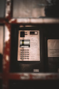 Close-up of a payphone inside a classic British telephone booth in Oxford, England.