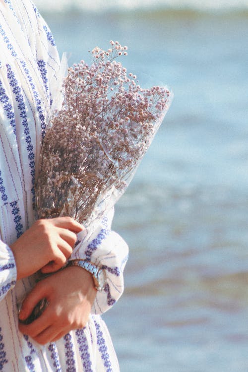 A Person Holding a Bouquet of Flowers