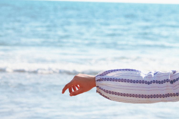 Womans Arm And Hand On The Background Of Sea 