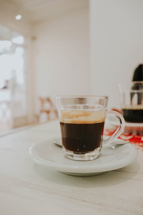 Close-Up Shot of a Glass of Coffee on a Saucer