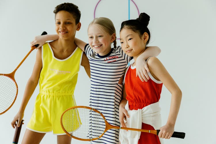 Children Holding Badminton Rackets