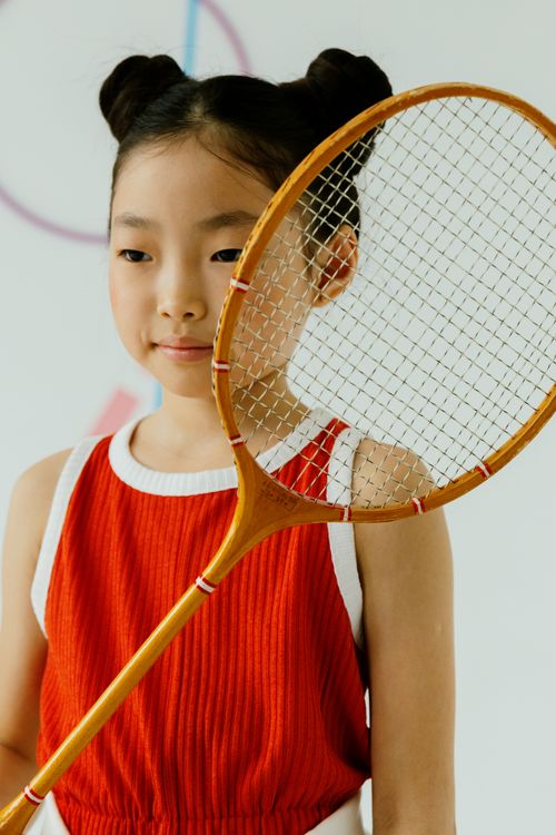 Free Confident young girl with vintage wooden racket in a bright room. Stock Photo