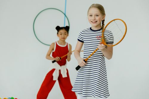 Free Two children enjoy indoor racquet games with smiles and energy. Stock Photo