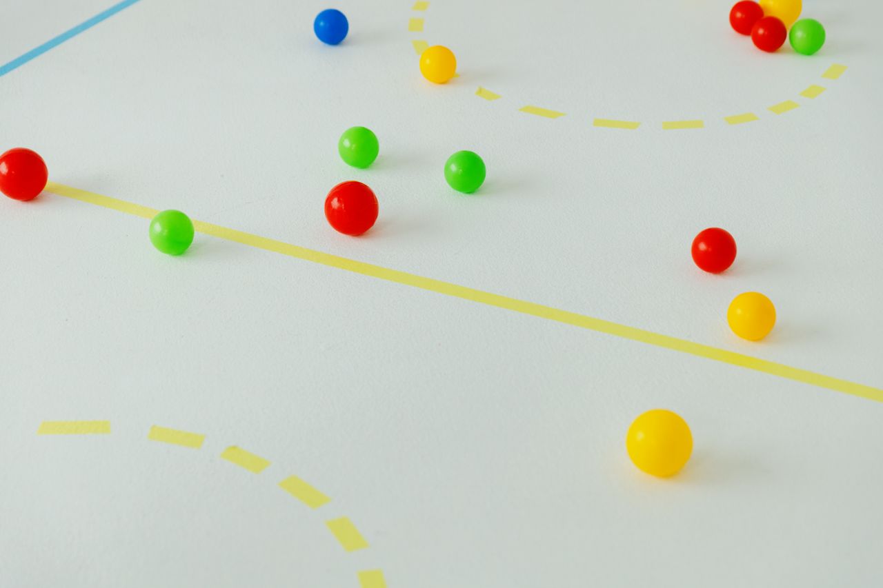 playful arrangement of colored balls on a marked white surface featuri
